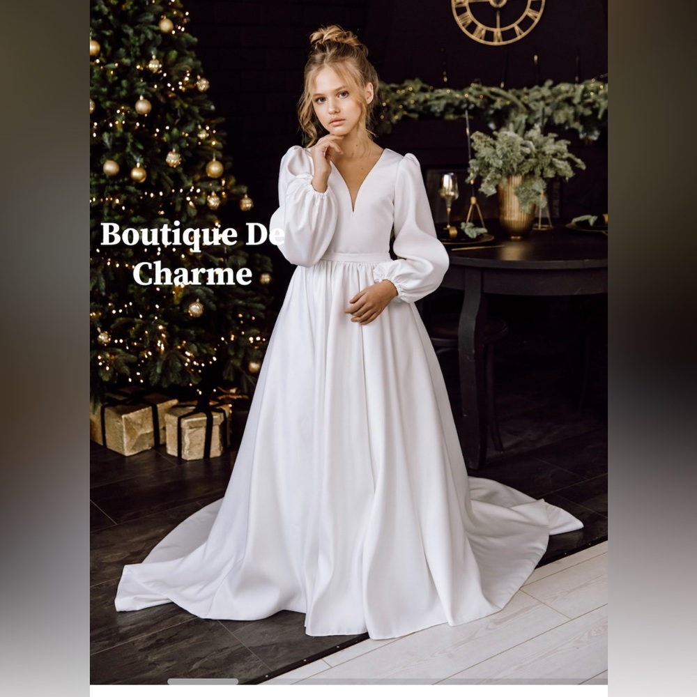 Beautiful cream junior bridesmaids or flower girl dress.